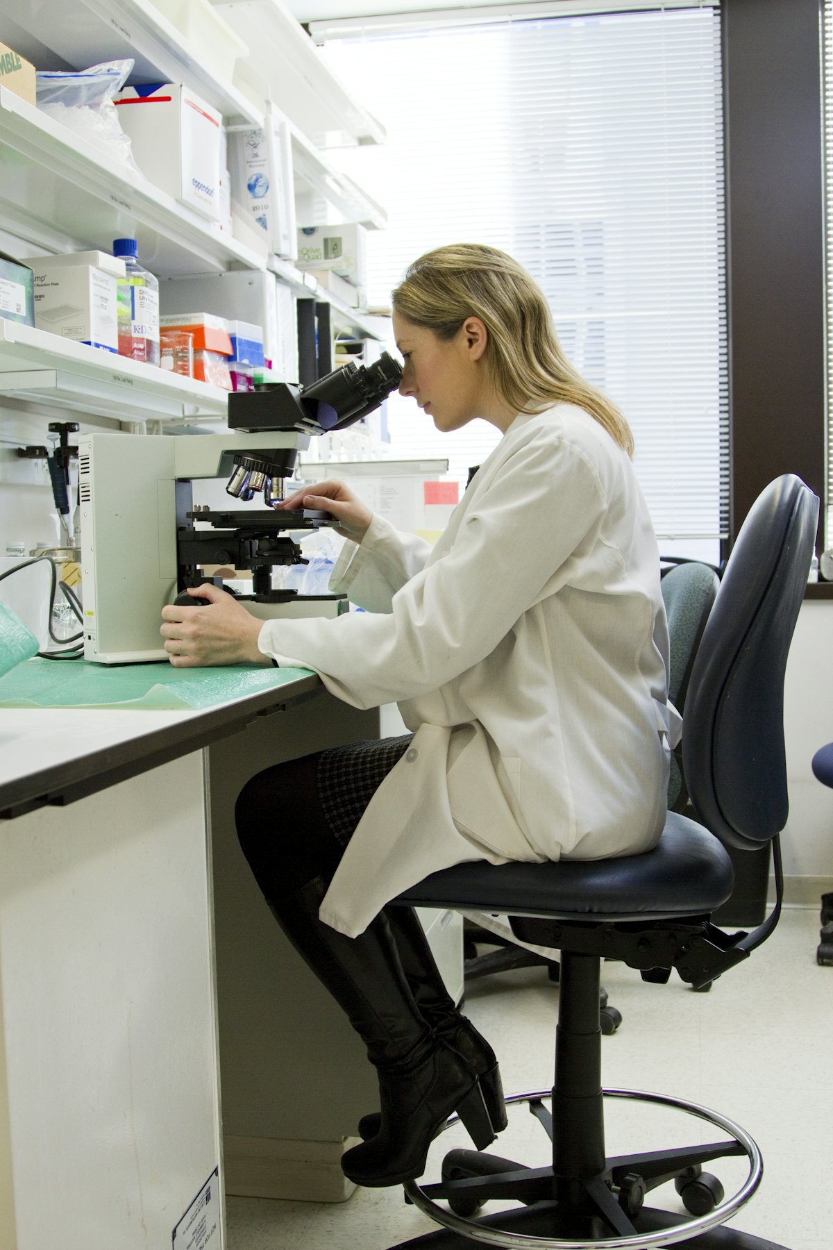 Scientist examining a sample under a microscope